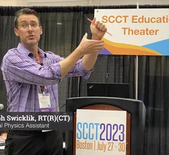 Joseph Swicklik, RT, Mayo Clinic, demonstrates how to use magic to calm pediatric patients during imaging exams.