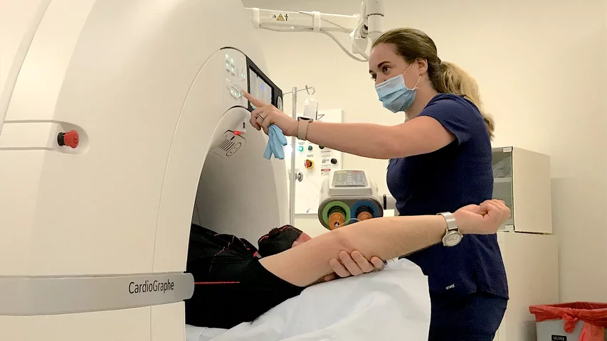 A technology preps a patient for a pre-procedural LAA occlusion workup scan on Duly Health and Care's Cardiographe cardiac CT scanner.