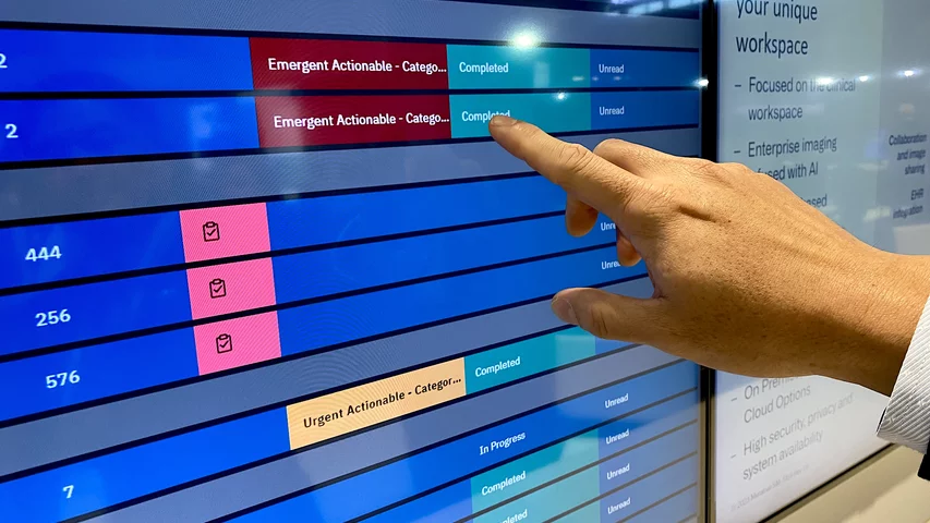 AI review of studies and spotting a suspected critical finding automatically bringing STAT reads to the top of the radiology worklist. Example from Merge enterprise imaging system. Photo by Dave Fornell #RSNA #RSNA23 #RSNA2023