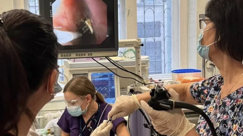 Physicians extracting a 19 cm toothbrush from the esophagus of a teenager who swallowed it by accident when trying to cause vomiting after eating in an attempt to loose weight. The hospital said they remove a few tooth brushes each year for this reason. Photos courtesy of Okhmatdyt Children's Hospital, Kyiv, Ukraine.