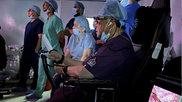 Sudhir Srivastava performing a left internal mammary artery (LIMA) takedown robot-assisted heart procedure on a patient in India, with the surgeon located at Georgetown Public Hospital Corp. (GPHC) in Guyana, 12,500 miles away.