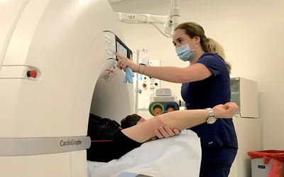 A technology preps a patient for a pre-procedural LAA occlusion workup scan on Duly Health and Care's Cardiographe cardiac CT scanner.