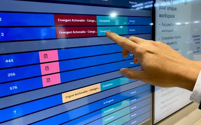 AI review of studies and spotting a suspected critical finding automatically bringing STAT reads to the top of the radiology worklist. Example from Merge enterprise imaging system. Photo by Dave Fornell #RSNA #RSNA23 #RSNA2023