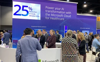 Nuance booth with messaging on how AI and improve workflow and radiologist efficiency. Nuance demonstrated a new AI implementation that can help automate more the of radiology report with less work by the radiologist. Solutions like this were highlighted across the expo floor because of the growing shortage of radiologists. Nuance AI workflow messaging at its booth at RSNA 2023. Photo by Dave Fornell. #RSNA #RSNA23 #RSNA2023