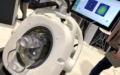 A work-in-progress, point-of-care brain microwave imaging system shown by Emu EMvision at RSNA 2023. Similar to ultrasound, but used radio-frequency waves and creates an image based on the RF signal that bounces back. It has liquid filled rubber bladder than expands to touch the patient's head to increase the signal to noise and improve the image quality. The device is aimed at emergency departments without access to MRI or CT for stroke assessments. Photo by Dave Fornell. #RSNA #RSNA23 #RSNA2023