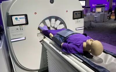 The GE Starguide SPECT-CT system uses arms containing the SPECT detectors that extent to the patient to enable clearer imaging. Photo by Dave Fornell. #RSNA #RSNA23 #RSNA2023