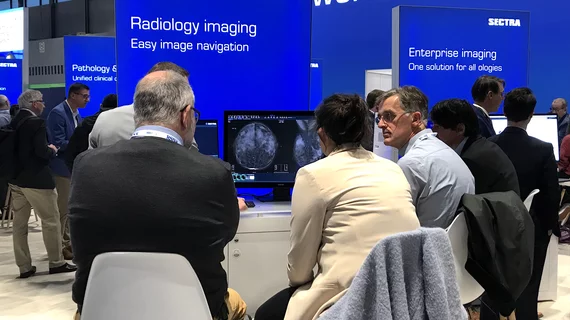 Attendees at RSNA 2022 in the Sectra booth learning about how enterprise imaging can help with workflows and connect numerous departments together for imaging. Photo by Dave Fornell 