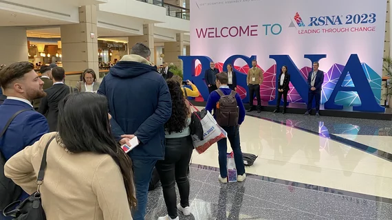 Attendees lined up to get photos in front of the large logo at RSNA 2023. Photo by Dave Fornell