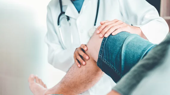 doctor looking at CLTI patient's leg