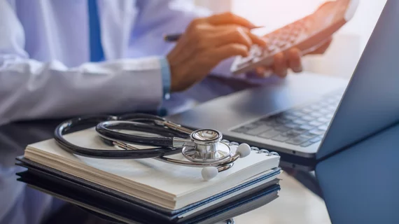 doctor comparing the costs of different medical treatments