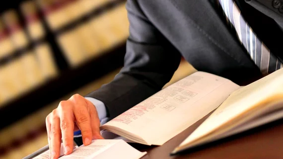 legal_research Lawyer studying law books.